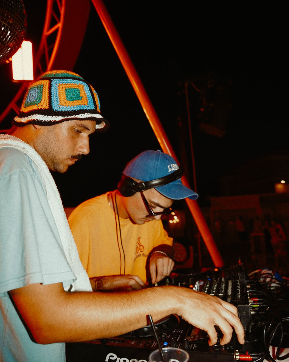 Due dj che mixano insieme, con il pubblico attorno.